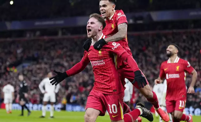 Liverpool's Alexis Mac Allister, left, celebrates with Luis Diaz after scoring the opening goal during the Champions League opening phase soccer match between Liverpool and Real Madrid at Anfield Stadium, Liverpool, England, Wednesday, Nov. 27, 2024. (Peter Byrne/PA via AP)