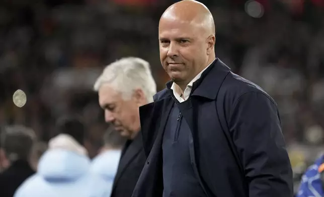 Liverpool's manager Arne Slot and Real Madrid's head coach Carlo Ancelotti, in the background, stand by the touchline before the Champions League opening phase soccer match between Liverpool and Real Madrid at Anfield Stadium, Liverpool, England, Wednesday, Nov. 27, 2024. (AP Photo/Jon Super)