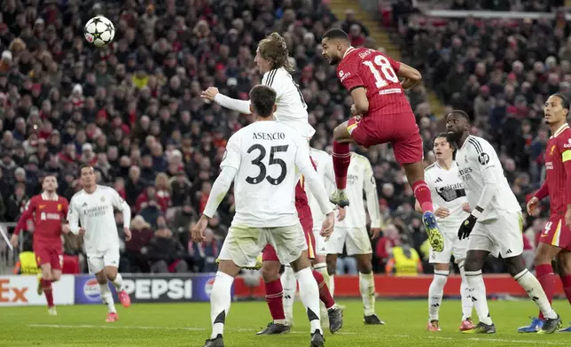 Liverpool's Cody Gakpo, center, scores his side's second goal during the Champions League opening phase soccer match between Liverpool and Real Madrid at Anfield Stadium, Liverpool, England, Wednesday, Nov. 27, 2024. (AP Photo/Jon Super)