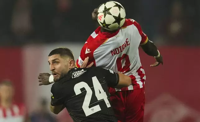 Red Star's Cherif Ndiaye reaches for a header over Stuttgart's Jeff Chabot during the Champions League opening phase soccer match between Red Star and Stuttgart at the Rajko Mitic Stadium in Belgrade, Serbia, Wednesday, Nov. 27, 2024. (AP Photo/Darko Vojinovic)