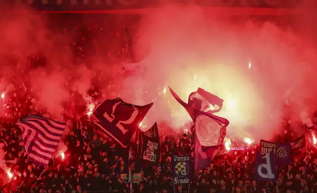 Supporters light flares during the Champions League soccer match between Dinamo Zagreb and Dortmund at Maksimir Stadium, in Zagreb, Croatia, Thursday, Nov. 28, 2024. (AP Photo)