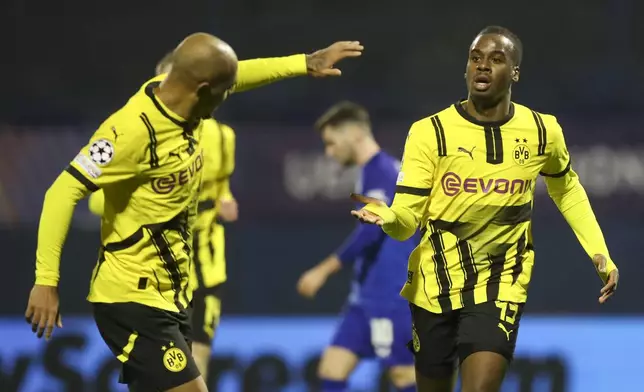 Dortmund's Jamie Bynoe-Gittens, right, celebrates after scoring his side's opening goal during the Champions League soccer match between Dinamo Zagreb and Dortmund at Maksimir Stadium, in Zagreb, Croatia, Wednesday, Nov. 27, 2024. (AP Photo)