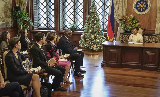 Philippine President Ferdinand Marcos Jr., right, meets with U.S. Defense Secretary Lloyd Austin, second right, and his delegation at the Malacanang Palace in Manila, Philippines Monday, Nov. 18, 2024. (AP Photo/Gerard Carreon, Pool)