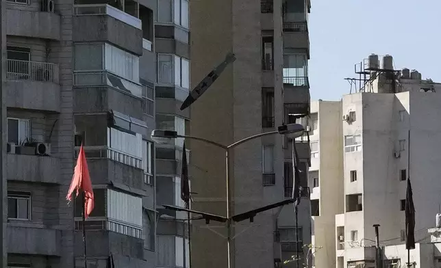 A bomb dropped from an Israeli jet hits a building in Tayouneh, Beirut, Lebanon, Friday, Nov. 15, 2024. (AP Photo/Hassan Ammar)