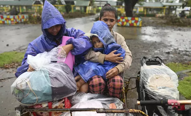 Residents of Santa Ana, Cagayan province, northern Philippines arrive at a school used a temporary evacuation center as Typhoon Usagi approaches Thursday, Nov. 14, 2024. (AP Photo/Noel Celis)