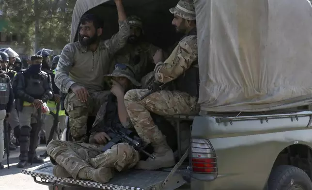 Pakistan's army troops move toward the Red Zone, which is an area that houses key government buildings, to take position ahead of the rally of supporters of imprisoned former premier Imran Khan's Pakistan Tehreek-e-Insaf party, in Islamabad, Pakistan, Tuesday, Nov. 26, 2024. (AP Photo/Ehsan Shahzad)