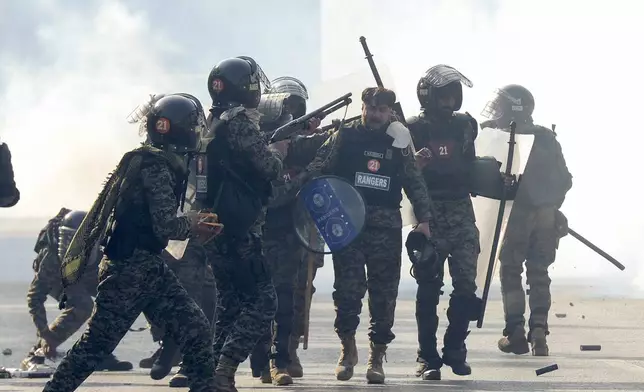 Paramilitary soldiers fire rubber bullets to disperse supporters of imprisoned former premier Imran Khan's Pakistan Tehreek-e-Insaf party, during clashes, in Islamabad, Pakistan, Tuesday, Nov. 26, 2024. (AP Photo/Irtisham Ahmed)