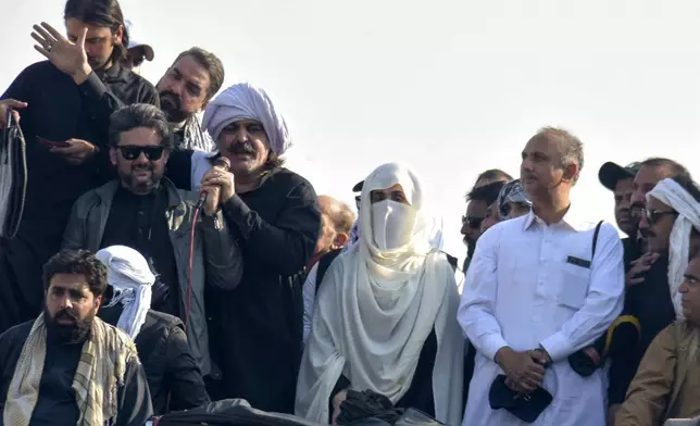 Bushra Bibi, center, wife of imprisoned former premier Imran Khan and leaders of Khan's party lead their supporters during a rally demanding Khan's release, in Islamabad, Pakistan, Tuesday, Nov. 26, 2024. (AP Photo/W.K. Yousufzai)
