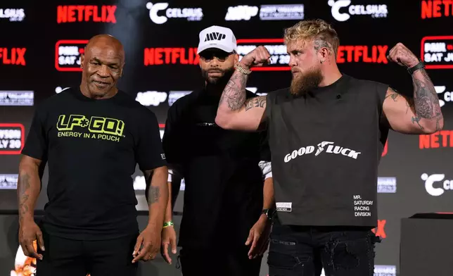 FILE - Mike Tyson, left, and Jake Paul, right, pose for photos during a news conference promoting their upcoming boxing bout, Thursday, May 16, 2024, in Arlington, Texas. (AP Photo/Sam Hodde, File)