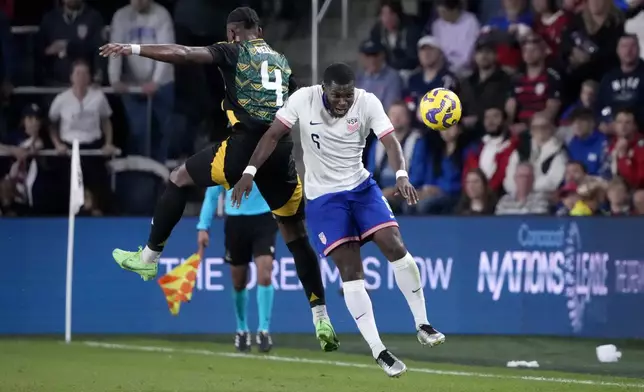 United States' Yunus Musah (6) and Jamaica's Amari'i Bell (4) battle for the ball during the first half in a CONCACAF Nations League quarterfinal second leg soccer match Monday, Nov. 18, 2024, in St. Louis. (AP Photo/Jeff Roberson)