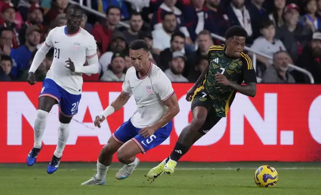 Jamaica's Leon Bailey, right, chases after a loose ball as United States' Antonee Robinson (5) and Tim Weah (21) defend during the first half in a CONCACAF Nations League quarterfinal second leg soccer match Monday, Nov. 18, 2024, in St. Louis. (AP Photo/Jeff Roberson)