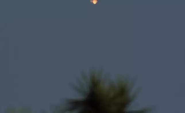 SpaceX's mega rocket booster returns to earth, but not the launch pad at Starbase in Boca Chica, Texas, Tuesday, Nov. 19, 2024. (AP Photo/Eric Gay)