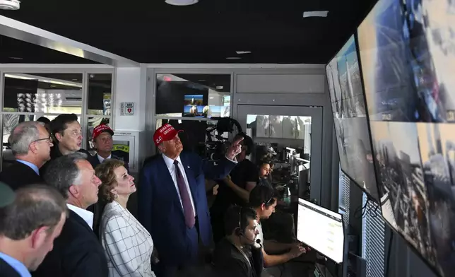 President-elect Donald Trump listens as Elon Musk explains the operations in the control room ahead of the launch of the sixth test flight of the SpaceX Starship rocket Tuesday, Nov. 19, 2024 in Brownsville, Texas. (Brandon Bell/Pool via AP)