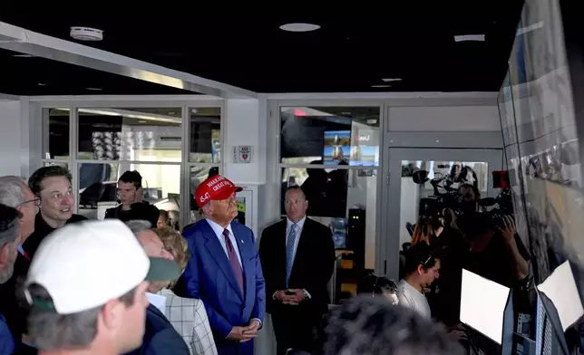 President-elect Donald Trump listens as Elon Musk explains the operations in the control room ahead of the launch of the sixth test flight of the SpaceX Starship rocket Tuesday, Nov. 19, 2024 in Brownsville, Texas. (Brandon Bell/Pool via AP)