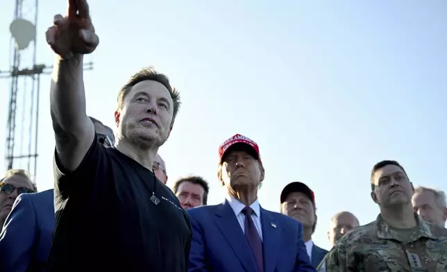 President-elect Donald Trump listens to Elon Musk at the launch of the sixth test flight of the SpaceX Starship rocket Tuesday, Nov. 19, 2024 in Boca Chica, Texas. (Brandon Bell/Pool via AP)