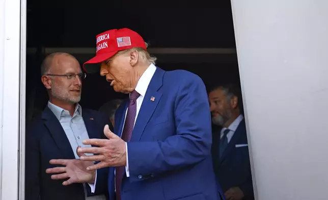 President-elect Donald Trump speaks with talks with Brendan Carr before the launch of the sixth test flight of the SpaceX Starship rocket Tuesday, Nov. 19, 2024 in Brownsville, Texas. (Brandon Bell/Pool via AP)