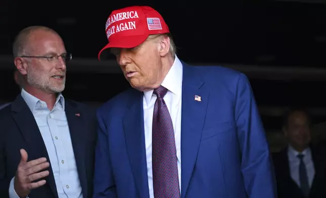 President-elect Donald Trump speaks with talks with Brendan Carr before the launch of the sixth test flight of the SpaceX Starship rocket Tuesday, Nov. 19, 2024 in Brownsville, Texas. (Brandon Bell/Pool via AP)