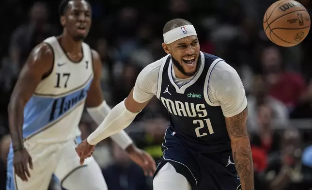 Dallas Mavericks center Daniel Gafford (21) loses the ball against Atlanta Hawks forward Onyeka Okongwu (17) during the first half of an NBA basketball game, Monday, Nov. 25, 2024, in Atlanta. (AP Photo/Mike Stewart)