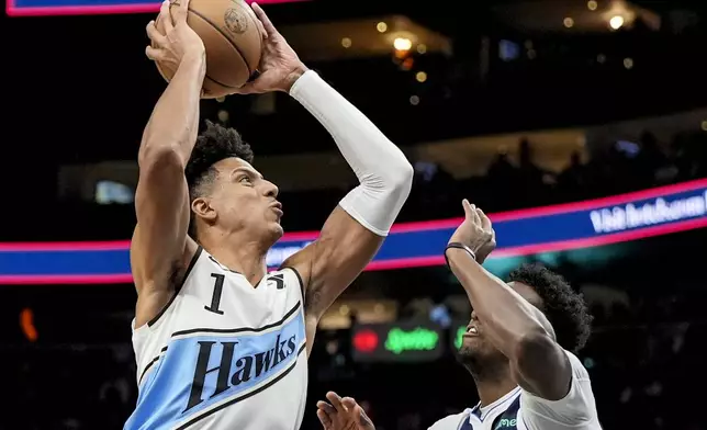 Atlanta Hawks forward Jalen Johnson (1) shoots against Dallas Mavericks forward Olivier-Maxence Prosper (8) during the first half of an NBA basketball game, Monday, Nov. 25, 2024, in Atlanta. (AP Photo/Mike Stewart)