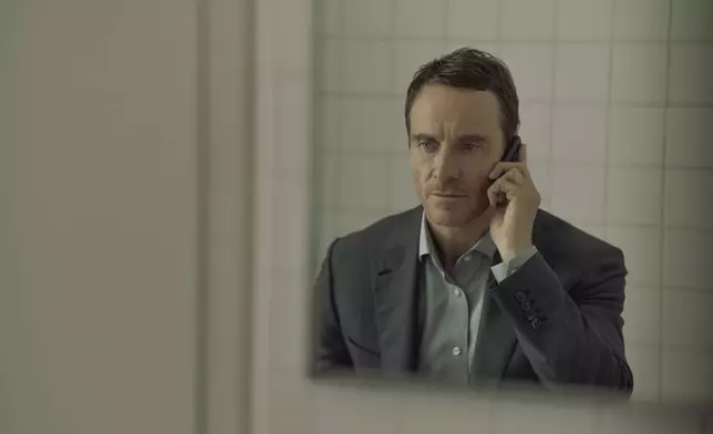 This image released by Paramount+ shows Michael Fassbender in a scene from "The Agency." (Luke Varley/Paramount+ via AP)