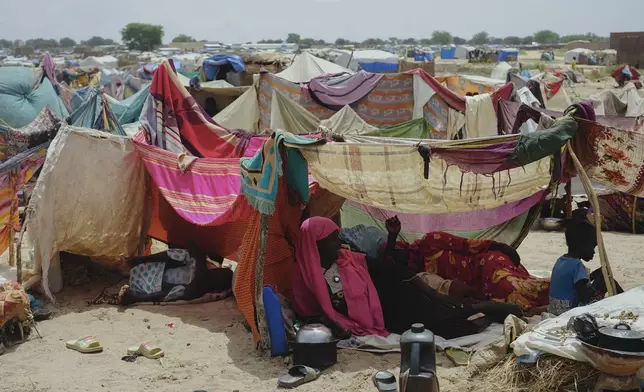 Women who fled war in Sudan rest in a refugee camp in Adre, Chad, Saturday, Oct. 5, 2024. (AP Photo/Sam Mednick)