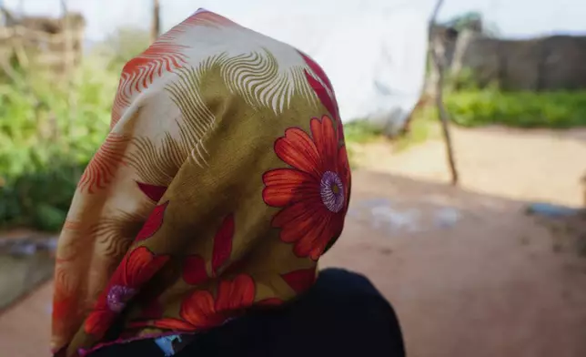 A woman who fled war in Sudan and requested anonymity because she feared retribution after reporting sexual exploitation, walks in a refugee camp in Adre, Chad, Saturday, Oct. 5, 2024. (AP Photo/Sam Mednick)