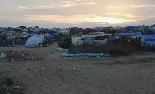 The sun sets over the camp set up for refugees who fled war in Sudan in Adre, Chad, Thursday, Oct. 3, 2024. (AP Photo/Sam Mednick)