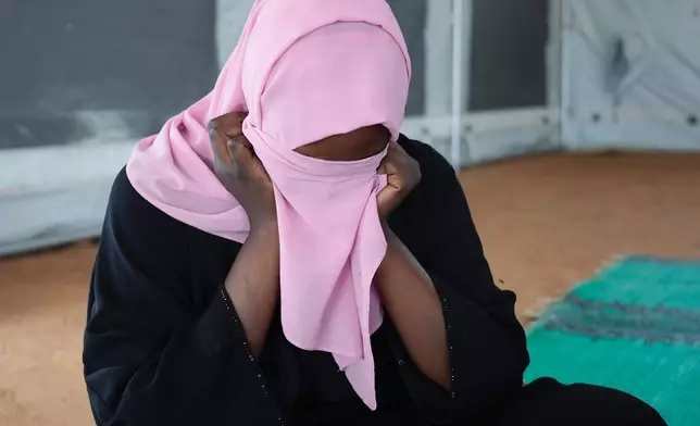 A woman who fled war in Sudan and requested anonymity because she feared retribution after reporting sexual exploitation, sits in a refugee camp in Adre, Chad, Thursday, Oct. 3, 2024. (AP Photo/Sam Mednick)