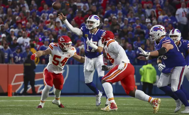 Buffalo Bills quarterback Josh Allen throws as Kansas City Chiefs linebacker Leo Chenal (54) defends during the first half of an NFL football game Sunday, Nov. 17, 2024, in Orchard Park, N.Y. (AP Photo/Jeffrey T. Barnes)