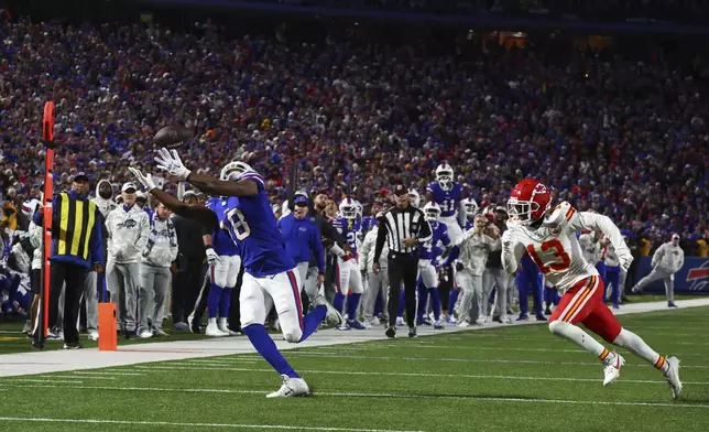 Buffalo Bills wide receiver Amari Cooper (18) makes a catch for a first down as Kansas City Chiefs cornerback Nazeeh Johnson (13) defends during the first half of an NFL football game Sunday, Nov. 17, 2024, in Orchard Park, N.Y. (AP Photo/Jeffrey T. Barnes)