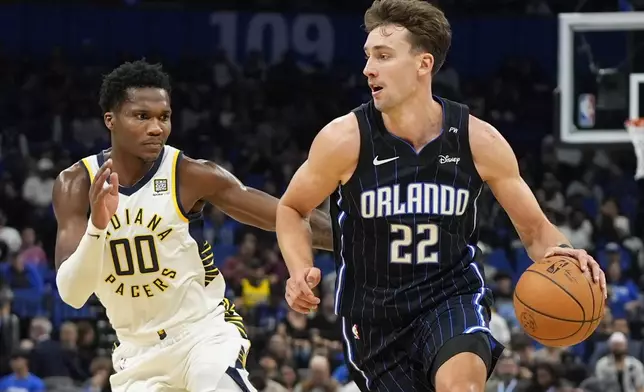 Orlando Magic forward Franz Wagner (22) drives past Indiana Pacers guard Bennedict Mathurin (00) during the first half of an NBA basketball game, Wednesday, Nov. 13, 2024, in Orlando, Fla. (AP Photo/John Raoux)