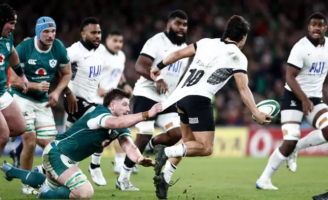 Ireland's Joe McCarthy, left, tackles Fiji's Caleb Muntz during the Autumn Nations Series rugby union match between Ireland and Fiji, at Aviva Stadium, Dublin, Ireland, Saturday, Nov. 23, 2024. (AP Photo/Peter Morrison)