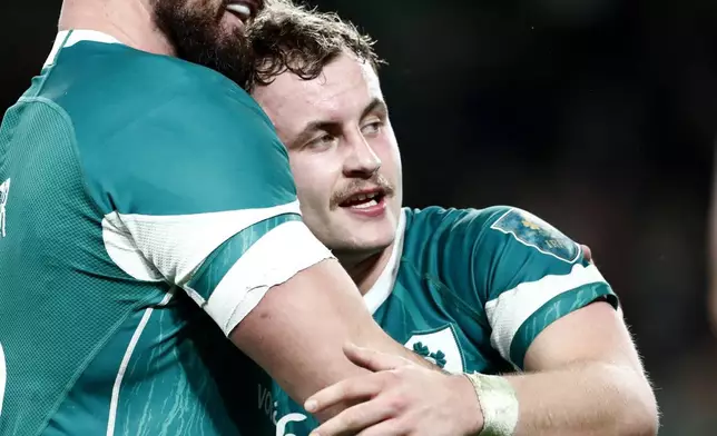 Ireland's Rónan Kelleher, left, celebrates with teammate Craig Casey following the Autumn Nations Series rugby union match between Ireland and Fiji, at Aviva Stadium, Dublin, Ireland, Saturday, Nov. 23, 2024. (AP Photo/Peter Morrison)