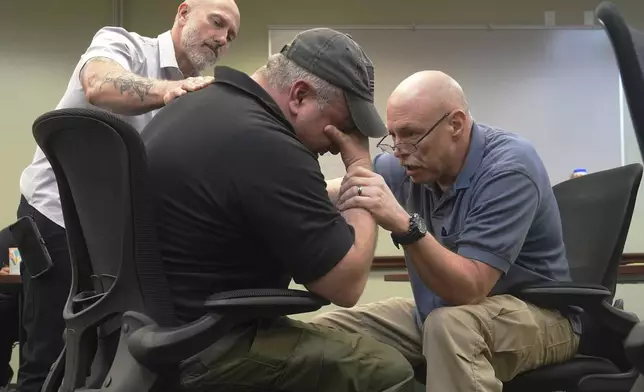 Border Patrol specialist Mitchell Holmes, right, and Fish and Wildlife Regional Law Enforcement agent Kevin Shinn, use skills they learned in the Border Patrol Chaplaincy academy during a training session, Wednesday, Nov. 20, 2024, in Dania Beach, Fla. (AP Photo/Marta Lavandier)