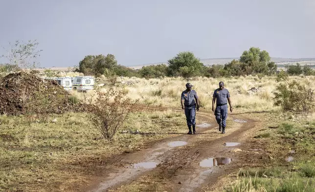 Police patrol at a mine shaft where an estimated 4000 illegal miners are trapped in a disused mine in Stilfontein, South Africa, Wednesday, Nov.13, 2024. (AP Photo)