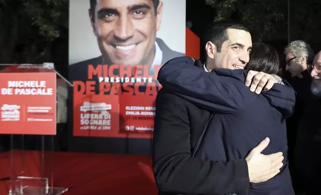 Democratic Party leader Elly Schlein, right, hugs candidate for the presidency of the region of Emilia Romagna Michele de Pascale, following regional elections, in Bologna, Italy, Monday, Nov. 18, 2024. (Guido Calamosca/LaPresse via AP)