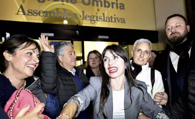 Center-left candidate Stefania Proietti, center, celebrates following regional elections in the region of Umbria, in Perugia, Italy, late Monday, Nov. 18, 2024. (Roberto Settonce/LaPresse via AP)