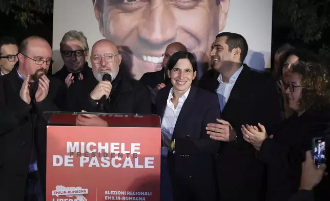 Democratic Party leader Elly Schlein, center, celebrates with candidate for the presidency of the region of Emilia Romagna Michele de Pascale, center right, following regional elections, in Bologna, Italy, Monday, Nov. 18, 2024. (Guido Calamosca/LaPresse via AP)