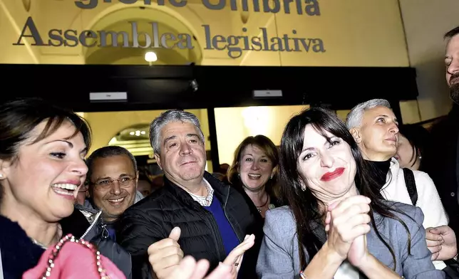 Center-left candidate Stefania Proietti, center right, celebrates following regional elections in the region of Umbria, in Perugia, Italy, late Monday, Nov. 18, 2024. (Roberto Settonce/LaPresse via AP)