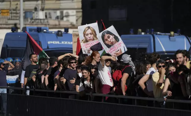 FILE -Demonstrators hold placards of Italian Premier Giorgia Meloni, left, and Italian Democratic Party Leader Elly Schlein reading: complicit in the genocide, as they take part in a national antigovernment demonstration, in Rome, June 1, 2024. (AP Photo/Grogorio Borgia, File)