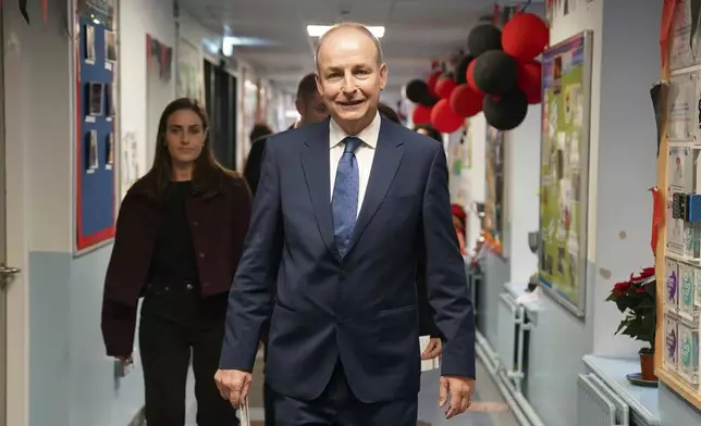 Minister for Foreign Affairs, and Minister for Defence and Fianna Fail leader Micheal Martin arrives to cast his vote at St Anthony's Boys' School, Beechwood Park, Ballinlough, Cork, as voters go to the polls for the 2024 General Election in Ireland, Friday, Nov. 29, 2024. (Jacob King/PA via AP)