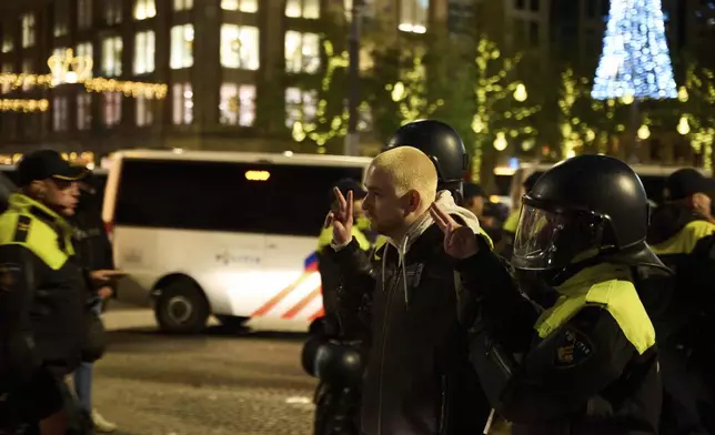 A pro-Palestinian protestor is arrested by police at a demonstration in Amsterdam, Netherlands, Wednesday, Nov. 13, 2024. (AP Photo/Bram Janssen)