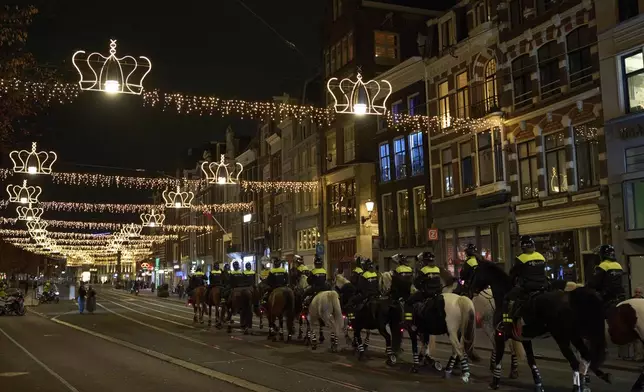 Police forces leave the Dam square after shutting down a pro-Palestinian protest at the square in Amsterdam, Netherlands, Wednesday, Nov. 13, 2024. (AP Photo/Bram Janssen)