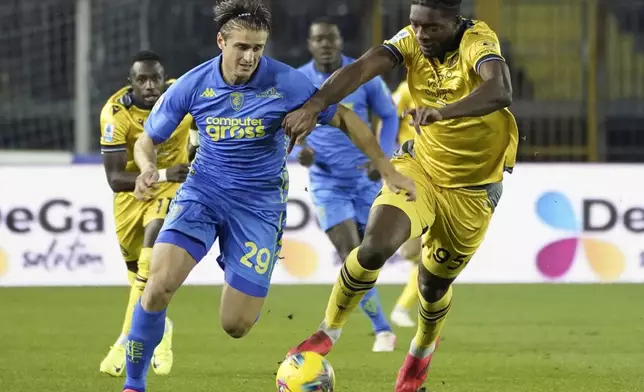 Empoli's Lorenzo Colombo, left, and Udinese's Jesper Karlstrom vie for the ball during the Serie A soccer match between Empoli and Udinese at the Carlo Castellani Stadium in Empoli, Italy, Monday, Nov. 25, 2024. (Marco Bucco/LaPresse via AP)