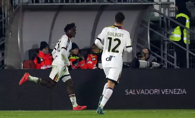 Lecce's Patrick Dorgu, left, celebrates after scoring the opening goal during the Italian Serie A soccer match between Venezia and Lecce in Venice, Italy, Monday, Nov. 25, 2024. (Paola Garbuio/LaPresse via AP)