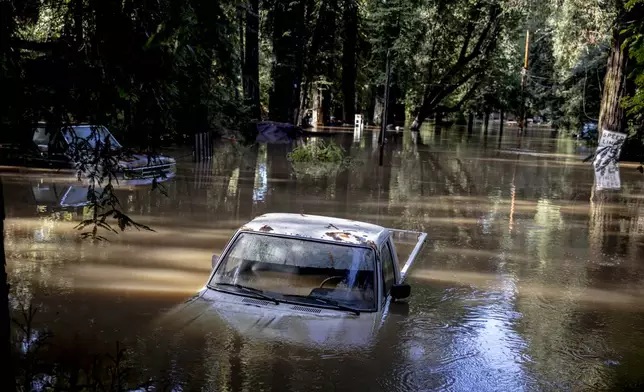 A car is seen submerged in flooded water at Mirabel RV Park &amp; Campground after severe weather in Forestville, Calif., Saturday, Nov. 23, 2024. (Stephen Lam/San Francisco Chronicle via AP)