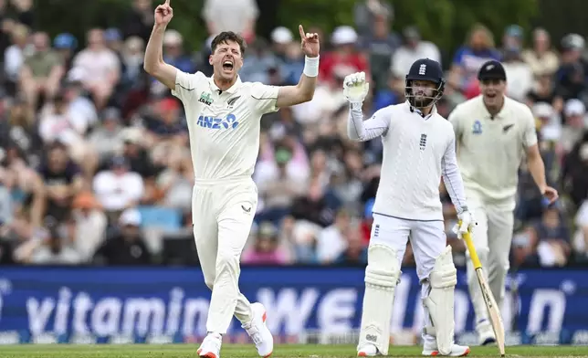 New Zealand's Matt Henry celebrates after taking the wicket of England's Zak Crawley during play on the second day of the first cricket test between England and New Zealand at Hagley Oval in Christchurch, New Zealand, Friday, Nov. 29, 2024. (Andrew Cornaga/Photosport via AP)