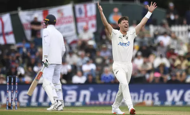 New Zealand's Matt Henry appeals successfully for the wicket of England's Zak Crawley, left, out LBW for no score during play on the second day of the first cricket test between England and New Zealand at Hagley Oval in Christchurch, New Zealand, Friday, Nov. 29, 2024. (Chris Symes/Photosport via AP)