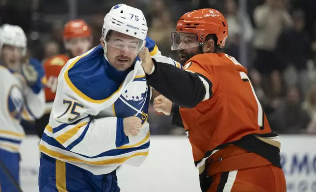 Anaheim Ducks defenseman Radko Gudas (7) and Buffalo Sabres defenseman Connor Clifton (75) fight during the second period of an NHL hockey game, Friday, Nov. 22, 2024, in Anaheim, Calif. (AP Photo/Kyusung Gong)