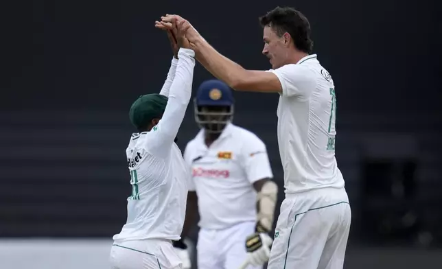 South Africa's Marco Jansen, right, celebrates with captain Temba Bavuma, after dismissing Sri Lanka's Angelo Mathews for 25 runs during the third day of the first Test cricket match between South Africa and Sri Lanka, at Kingsmead stadium in Durban, South Africa, Friday, Nov. 29, 2024. (AP Photo/Themba Hadebe)